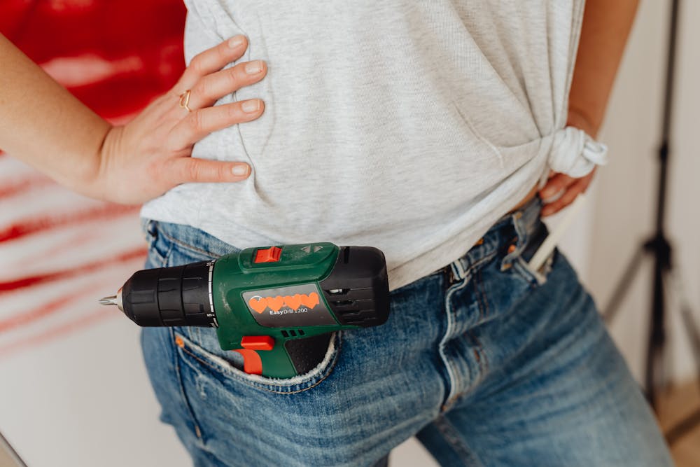 a homeowner with a portable drill in the pocket